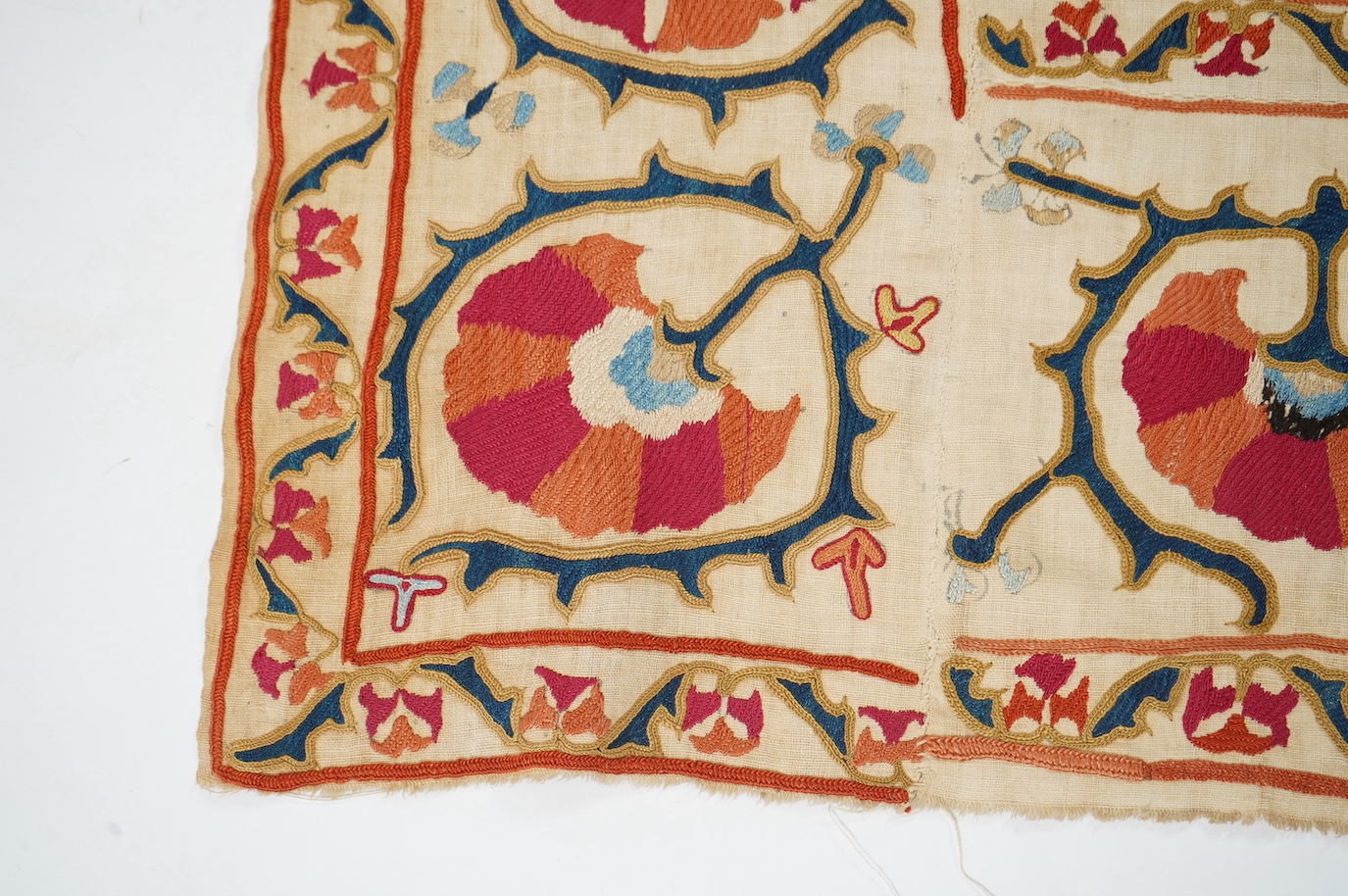A 19th century Uzbekistan Suzani, hand embroidered hanging. Made from hand woven linen panels each approximately 28cm wide x 167cm long. Hand embroidered with silk hand dyed threads, in orange, red, blue and yellows, usi